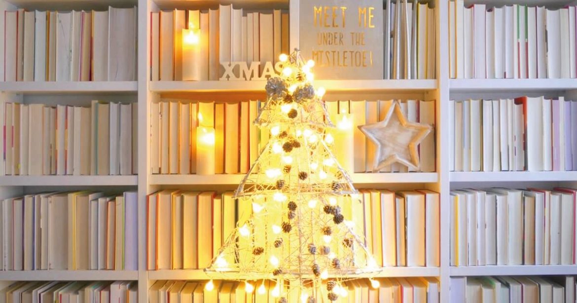 Christmas Book Club - christmas tree lights against a bookcase