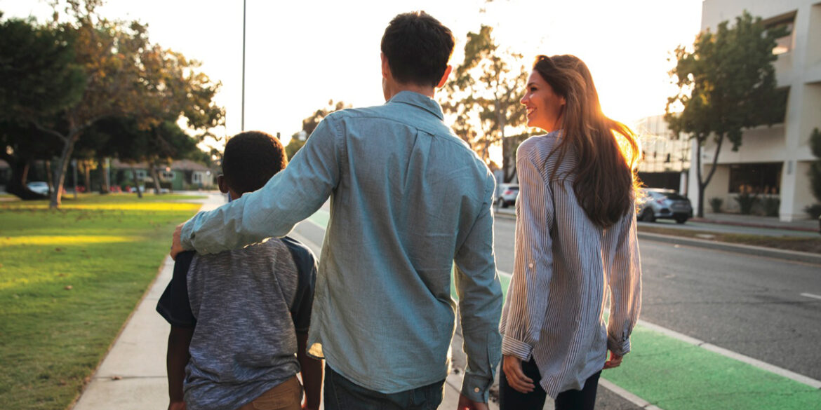 family-of-three-facing-away