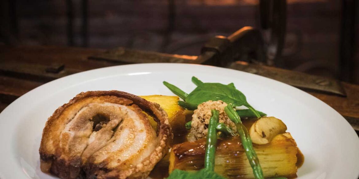 Close up photograph of half a plate of food against a dark backdrop