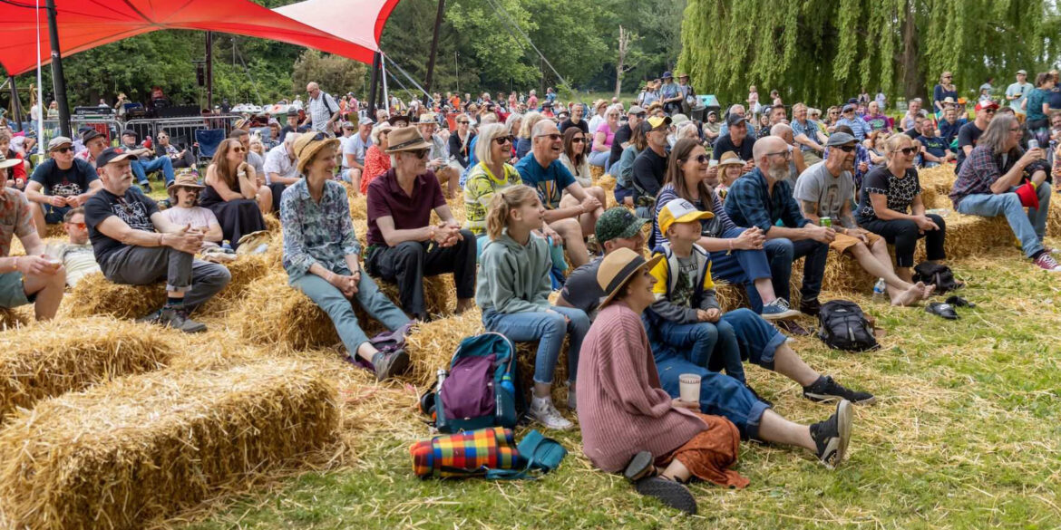 Audience on straw bales at Red Rooster Festival