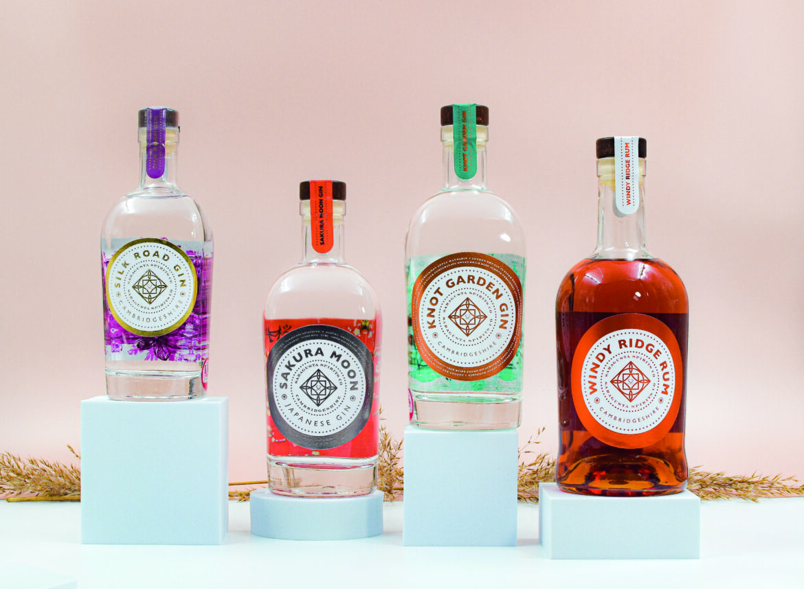 Four Saragusta spirit bottles on podiums of different sizes