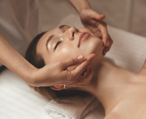 Young woman getting spa treatment with head massage at a spa center