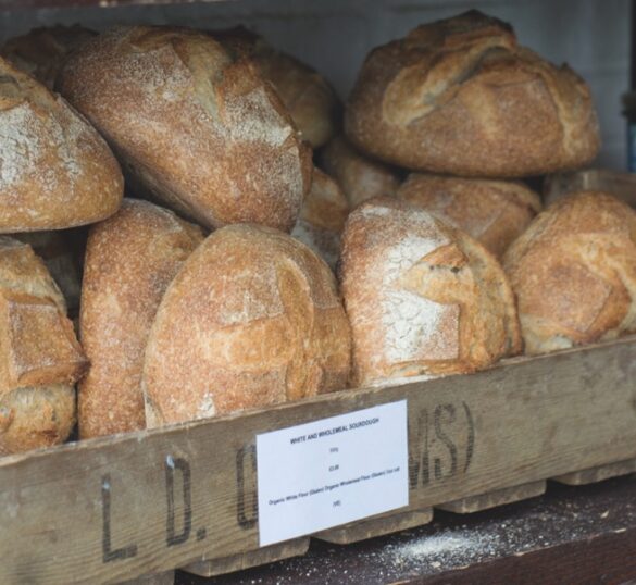 A shelf of bread rolls with a label in front