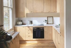 A light modern kitchen with light wood counters and cupboards