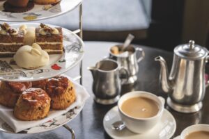 A traditional afternoon tea with cakes and drinks on a table