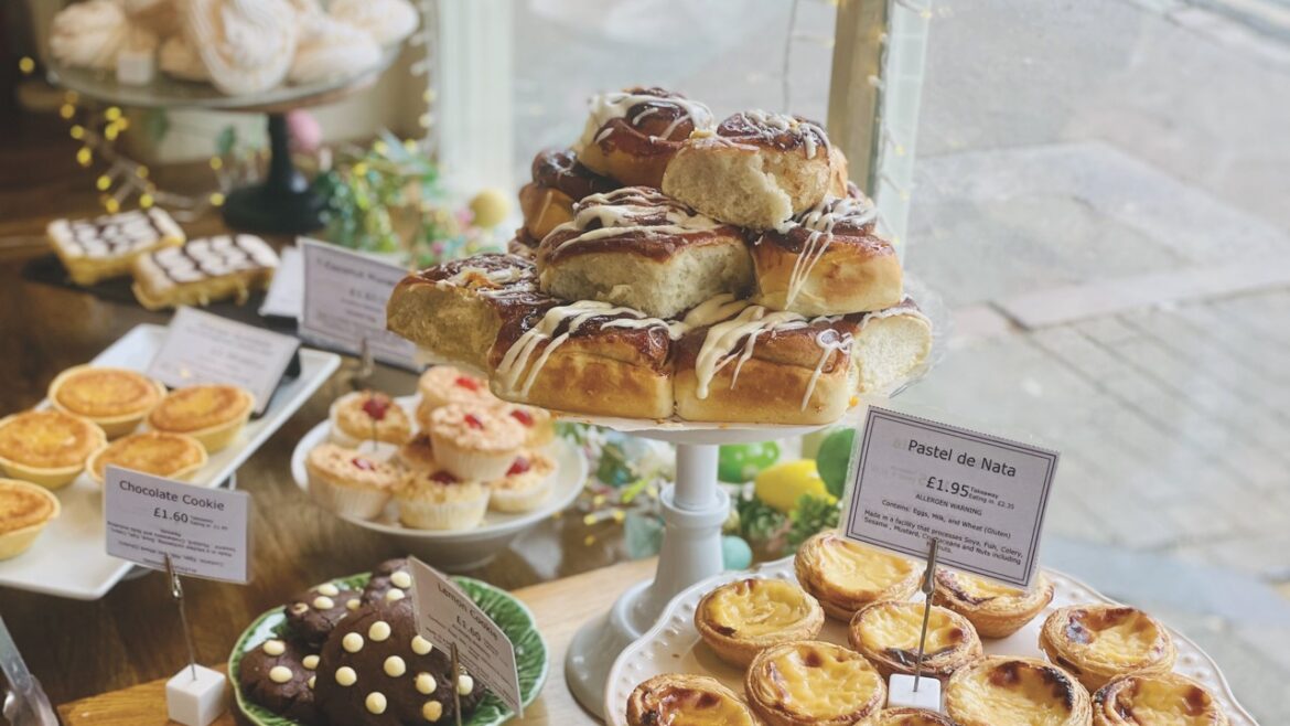 A shop window display filled with cakes and sweet treats