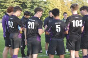 Students at Kimbolton School stand wearing sports uniform