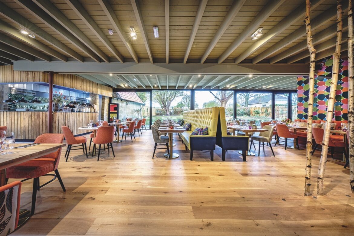 The spacious Carpenters Arms pub with wooden floors and empty rows of comfy tables