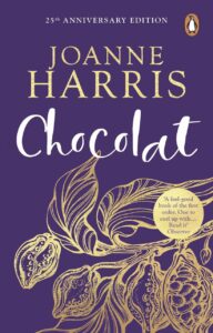 A book cover titled Chocolat with a purple background and gilded gold cocoa beans