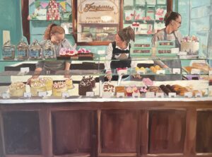 Three people working behind a counter at a cake shop named Fitzbillies