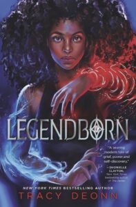 Front cover of a book titled Legendborn showing an illustration of a girl with light wrapping around her arms