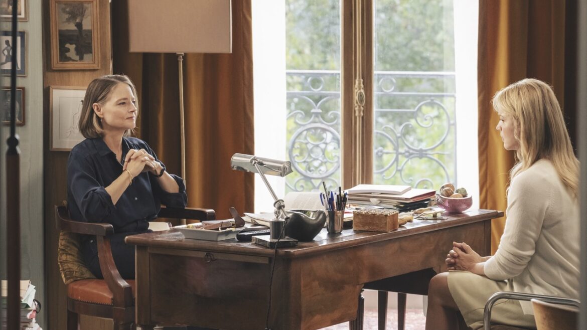 Two women sit at a desk, conducting an interview