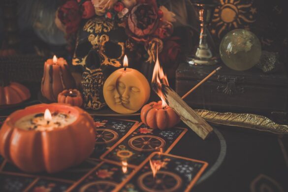 A collection of witch supplies, including pumpkin candles and cards