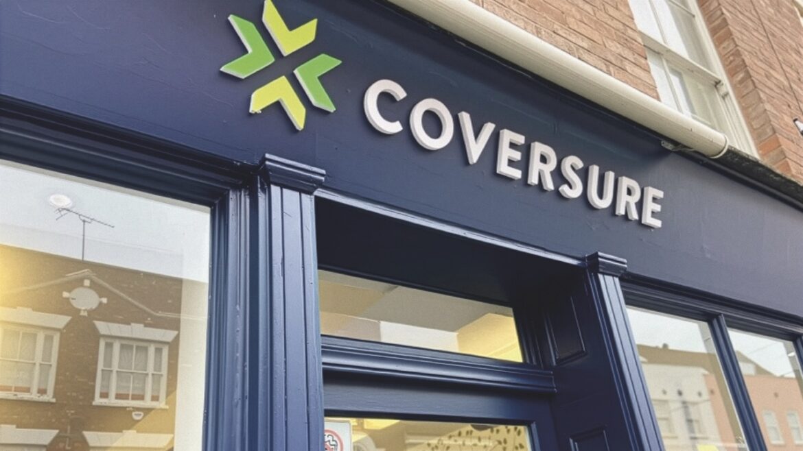 Low view of the front of a navy shop with large windows and signage saying "Coversure"