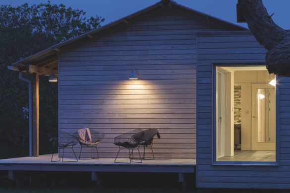 The outside of a wooden lodge at nighttime