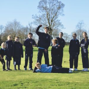A group of young children celebrating on a playing field