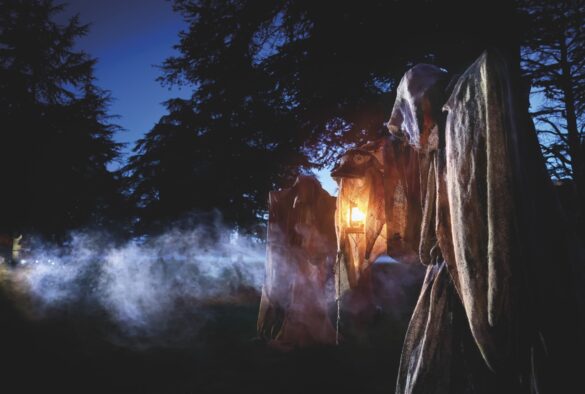 A spooky stone statue in a moonlit atmosphere
