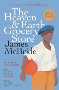 A book cover with an outline of a person holding an orange ball and titled "The Heaven & Earth Grocery Store"