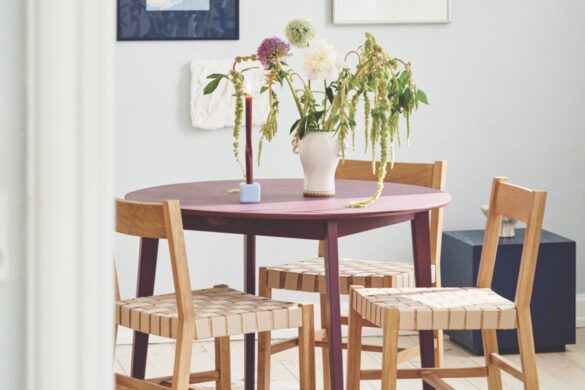 A modern store with a round wooden table and chairs