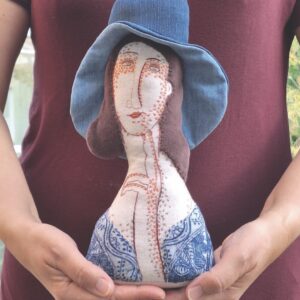 A sewn jumper showing a woman wearing a blue hat