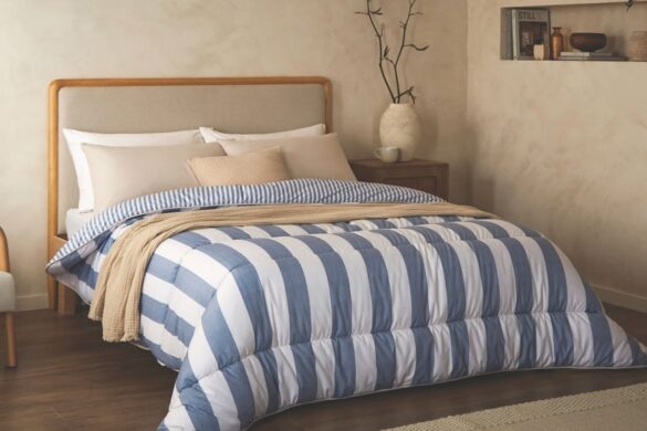 A bed with blue and white striped bedding