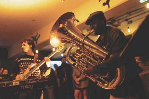 Close up of a band members playing trombone and guitar in golden light