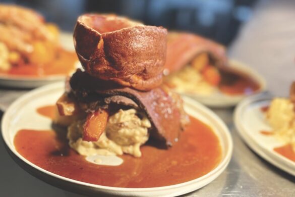 Christmas in the countryside A dish with meat and a Yorkshire pudding in gravy on a white plate