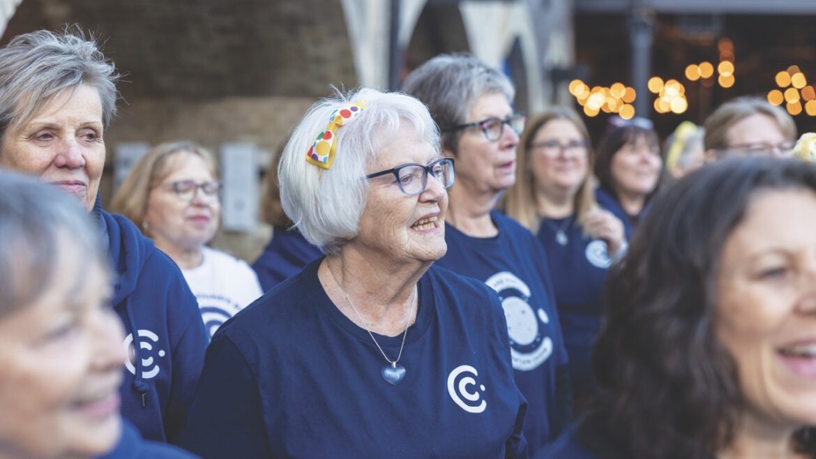 A choir wearing purple t-shirts standing in rows