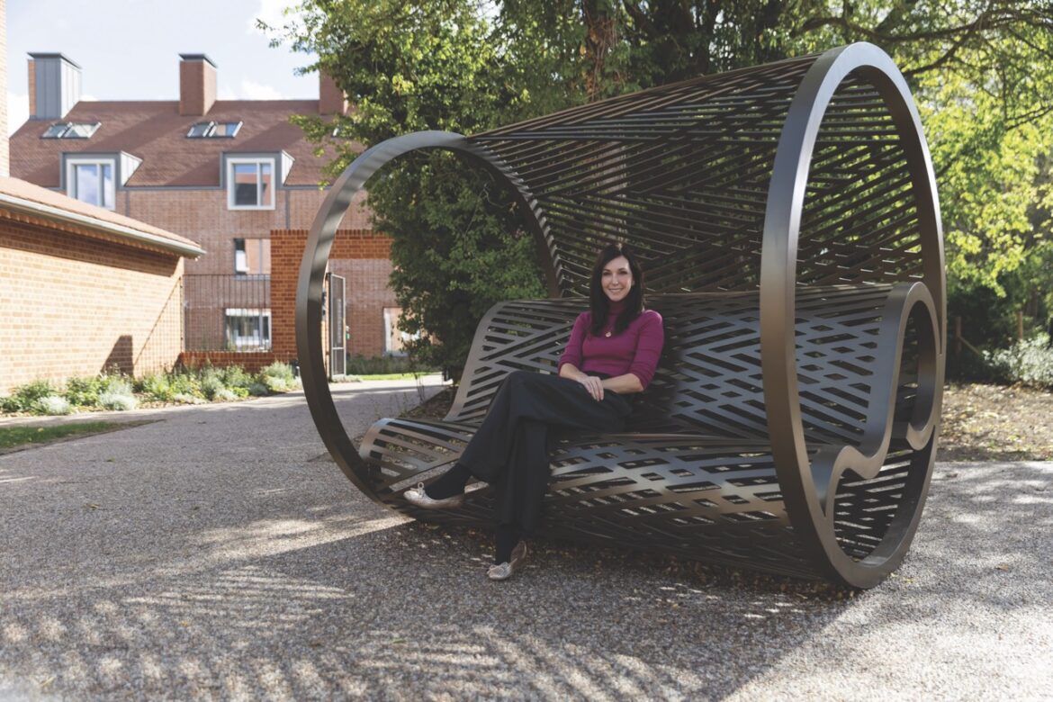 A woman sitting on a curved bench