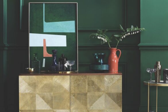 Swoon Editions shows that bars are being cleverly integrated into living spaces through the use of nooks and alcoves A modern living area with green walks and a gold home bar next to an orange stall