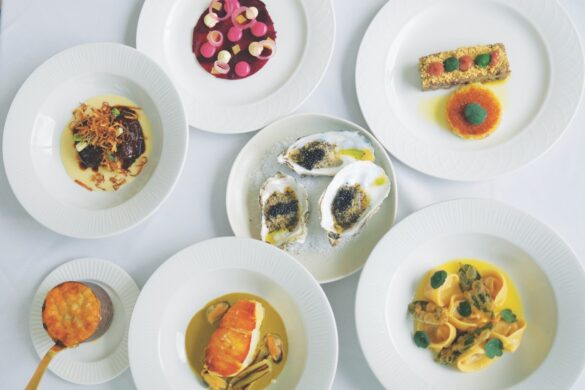 Top view of neat seafood dishes on white plates