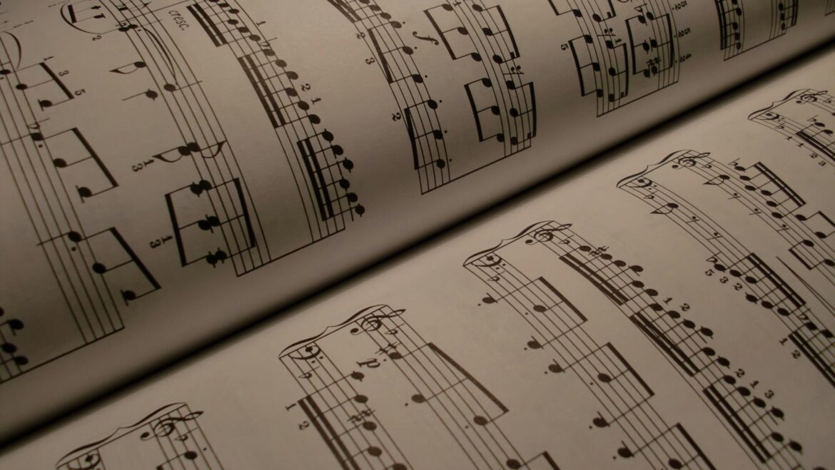 A close up of a book containing sheet music