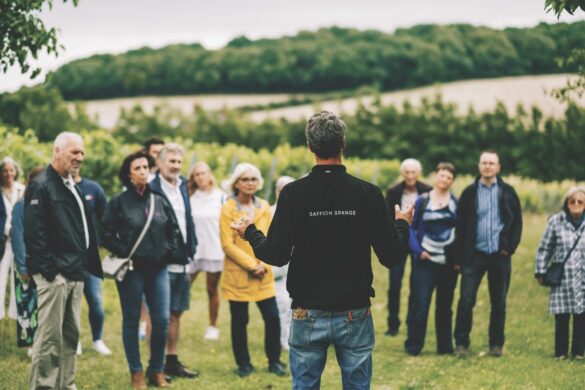 A group surrounding a man standing in a field