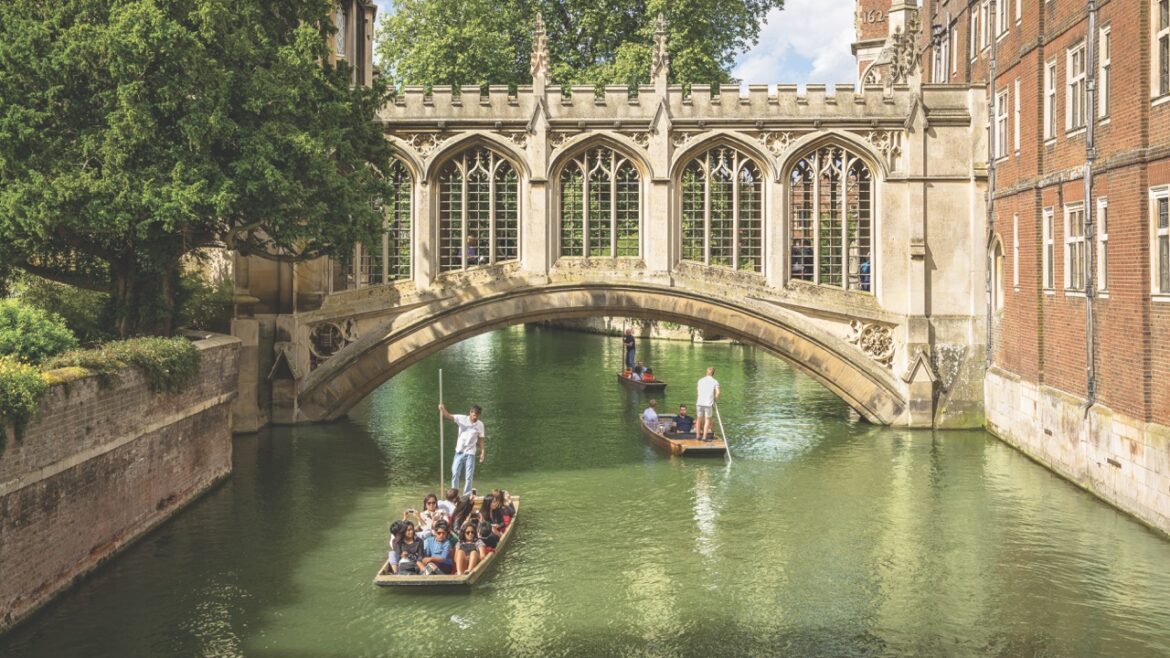 Punts travelling down the River Cam on a springlike day