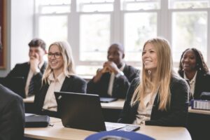 A classroom of sixth form students smiling