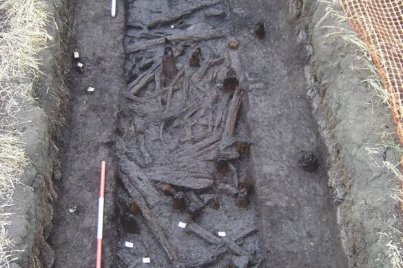 An archaeological pit showing muddy debris