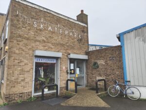 The exterior of a brick building called Skatepark
