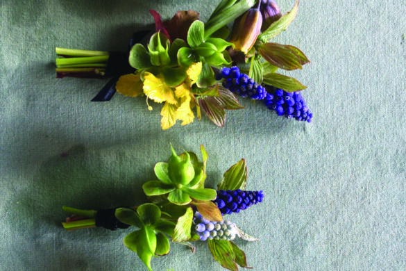 A line of bouquets including purple and yellow flowers