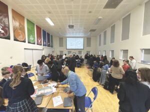 A hall packed with students and adults