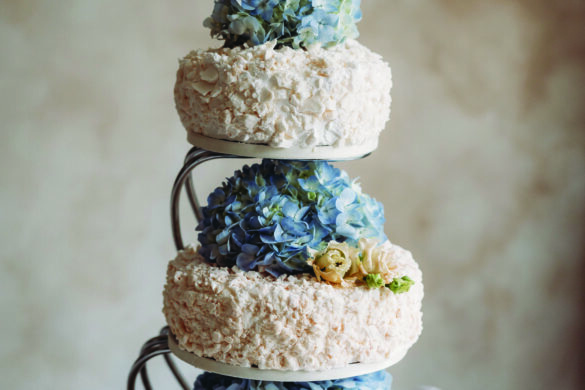 A blue and white tiered wedding cake