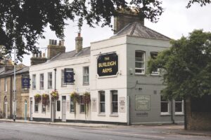 The outside of a white pub called The Burleigh Arms
