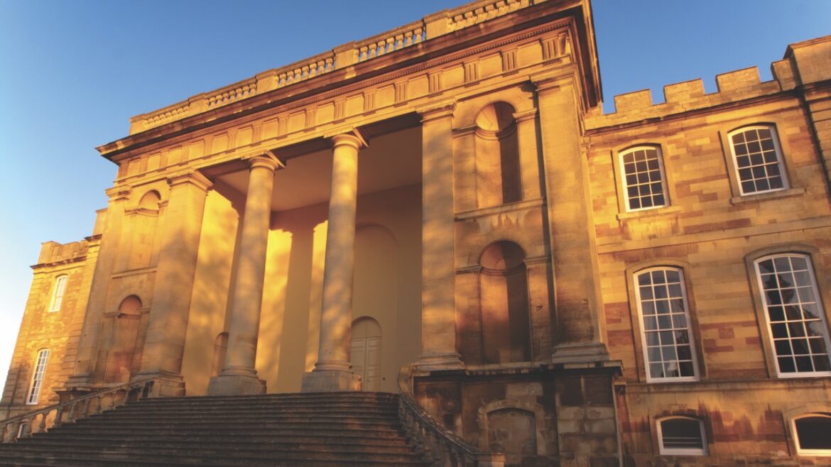 The exterior of a grand building in yellow sunlight