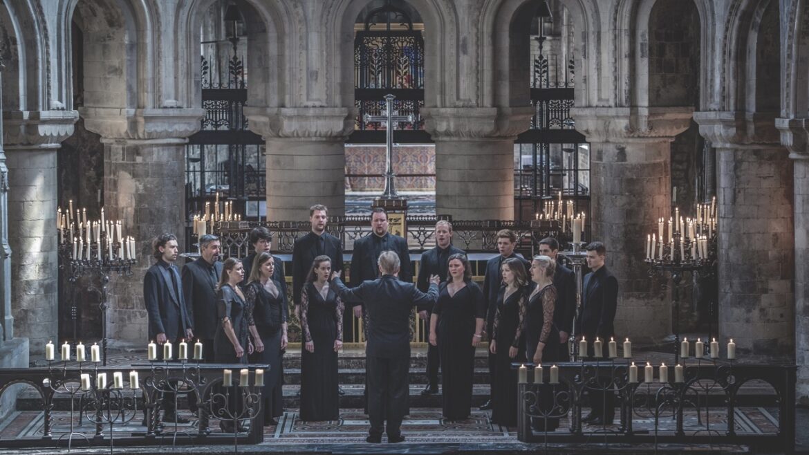 An choir with a conductor singing on a gothic stage, surrounded by candles