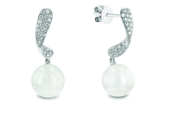 A pair of gem and white ball earrings