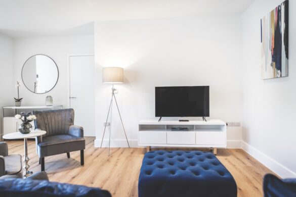 A modern living room with a large lamp and blue furnishings